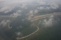 The Netherlands coastline, lighthouse and harbour viewed from the sky from a plane window