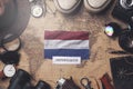 Netherlands Flag Between Traveler`s Accessories on Old Vintage Map. Overhead Shot Royalty Free Stock Photo