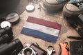 Netherlands Flag Between Traveler`s Accessories on Old Vintage Map. Tourist Destination Concept Royalty Free Stock Photo