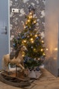 The Netherlands, Friesland. 5 january -2020. Nicely decorated blue kitchen with Christmas tree, a wooden vintage rocking horse