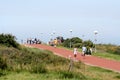 Visitors crossing the dunes to reach te beach