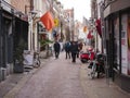 Netherlands, Holland, Harlem, January 30st 2019 at 2.29pm. narrow little shopping street with shops, pedestrians, bicycles,