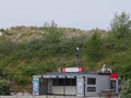 Netherlands, Kamperland, May 9th 2019 1 pm 15, Snack bar in front of a dune, advertising signs in Dutch. The main ones in