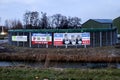 Netherlands, March 2023 -Board with election posters at farm with protest signs and anti coalition banners by angry farmer