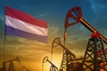Netherlands oil industry concept. Industrial illustration - Netherlands flag and oil wells against the blue and yellow sunset sky