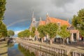 View along the main canal in the autumn with a dramatic sky and rainbow