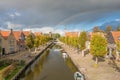 View along the main canal in the autumn with a dramatic sky and rainbow