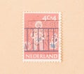 A stamp printed in the Netherlands shows a baby, circa 1960