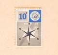 A stamp printed in the Netherlands shows a compass, circa 1960