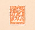 A stamp printed in the Netherlands shows the dutch holiday of Sint Maarten, circa 1960