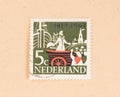 A stamp printed in the Netherlands shows a man in a boat, circa 1960