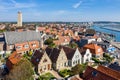 Brandaris lighthouse and Westerkerk, harbour and historical houses of West-Terschelling town. West Frisian Islands. Royalty Free Stock Photo