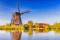 Netherlands Traveling Concepts. Traditional Dutch Windmill and Houses in Kinderdijk Village in the Netherlands At Daytime Royalty Free Stock Photo