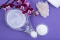 Neti Pot, pile of Saline, Purple Orchid Flowers, Clear Quartz Cluster and rolled up White Towels on purple background. Sinus wash. Royalty Free Stock Photo