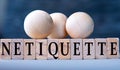 NETIQUETTE - word on wooden blocks on dark blue background