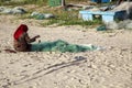 Nets for catching crabs and shrimp, woman unravels the nets