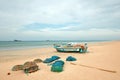 Nets, traps, baskets, and ropes next to fishing boat on Nilaveli beach in Trincomalee Sri Lanka Royalty Free Stock Photo