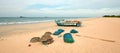 Nets, traps, baskets, and ropes next to fishing boat on Nilaveli beach in Trincomalee Sri Lanka Royalty Free Stock Photo