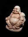 Netsuke - Japanese man in a robe with a ball in his hand isolated on black background Royalty Free Stock Photo
