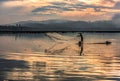 Fisherman catching fish early morning Royalty Free Stock Photo