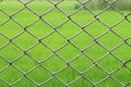 Metal netting, Mesh fence iron Rusty barbed wire detention center security, Chain link fence close up on green nature background, Royalty Free Stock Photo