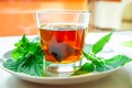 Nettle infusion with nettle leaves in a transparent cup