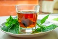 Nettle infusion with nettle leaves in a transparent cup