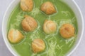 Nettle soup with peas puff in bowl closeup selective focus Royalty Free Stock Photo