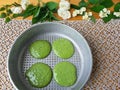 Nettles green pancakes with rose petals,