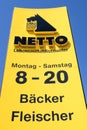 Netto Lebensmitteldiscounter sign against blue sky