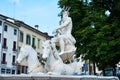 Nettuno fountain white romantic sculpture, detail and trees, in Conegliano Veneto, Treviso, Italy