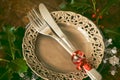 Netural, scandinavian style christmas dinner table setting: simple wooden table with silverware