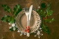 Netural, scandinavian style christmas dinner table setting: simple wooden table with silverware