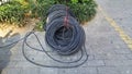 The network cables for municipal construction are placed on the road. Close up of a bundle of lines. Royalty Free Stock Photo