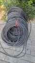 The network cables for municipal construction are placed on the road. Close up of a bundle of lines. Royalty Free Stock Photo