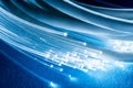 Network cables and optical fibers with light on blue background