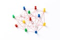 Network with colorful pins and string,  linked together with string on a white background suggesting a network of connections Royalty Free Stock Photo