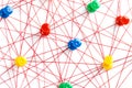 Network with colorful pins and string,  linked together with string on a white background suggesting a network of connections Royalty Free Stock Photo