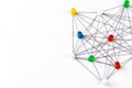 Network with colorful pins and string,  linked together with string on a white background suggesting a network of connections Royalty Free Stock Photo