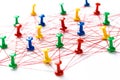 Network with colorful pins and string,  linked together with string on a white background suggesting a network of connections Royalty Free Stock Photo