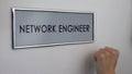 Network engineer office door, hand knocking closeup, database administrator