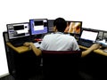 Network engineer woking with multiple monitors