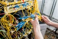 Network engineer working in server room. Connecting network cables to switches Royalty Free Stock Photo