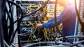 Network engineer working in server room. Connecting network cables to switches Royalty Free Stock Photo