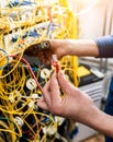 Network engineer working in server room. Connecting network cables to switches Royalty Free Stock Photo