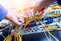 Network engineer working in server room. Connecting network cables to switches Royalty Free Stock Photo