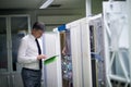 Network engineer working in server room Royalty Free Stock Photo