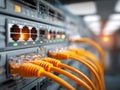 Network equipment with connected yellow Ethernet cables showing illuminated activity lights inside a server room or data center Royalty Free Stock Photo
