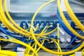 Network hub and patch UTP LAN cables in rack cabinet, close up Royalty Free Stock Photo