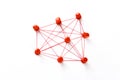 Network with red pins and string,  linked together with string on a white background suggesting a network of connections Royalty Free Stock Photo